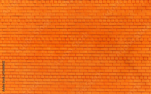 a brick wall painted orange as a background or texture