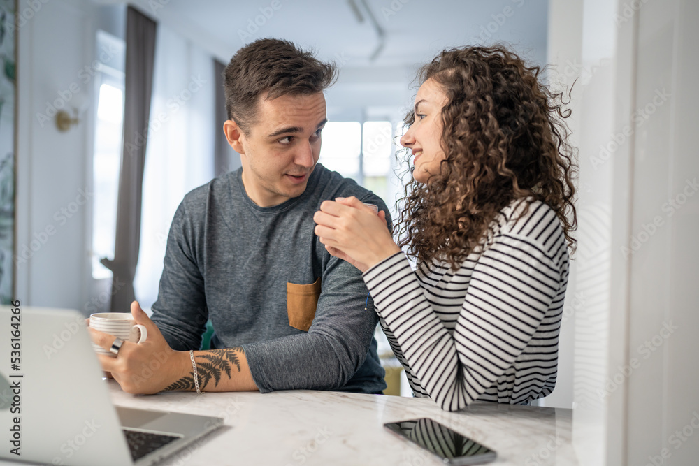 Fototapeta premium happy couple using laptop computer with cup of coffee morning routine