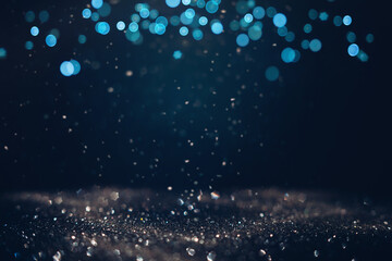 Glowing in the dark defocused glitter texture with blue bokeh lights and snow. Christmas and winter holidays background
