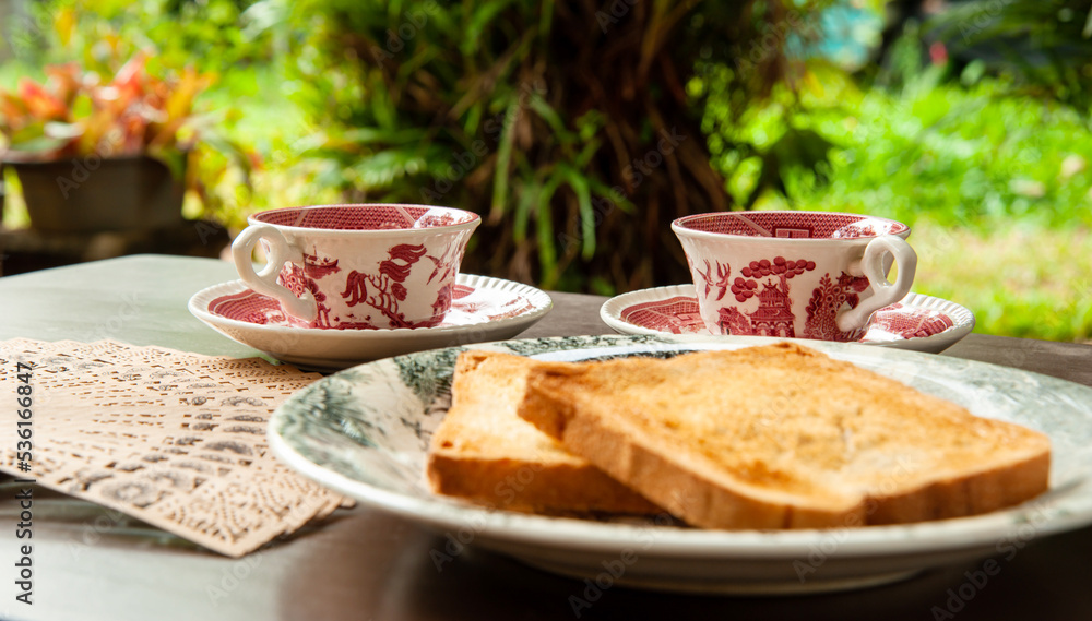tea and toast at evening English tea on antique cups with toasted bread ...
