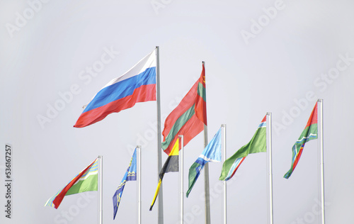 national flag of Transnistria and Russia against the sky. flags flutter in the wind. unity of the fraternal peoples of the former Soviet Union