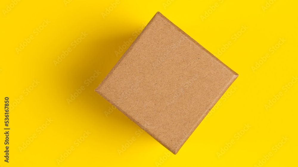 Brown craft paper or carton box with lid mock up on yellow background. Top view of blank small paper box. Brown cardboard box. Mockup photo Brown craft paper or carton box with lid mock up on yellow background. Top view of blank small paper box. Brown cardboard box. Mockup photo