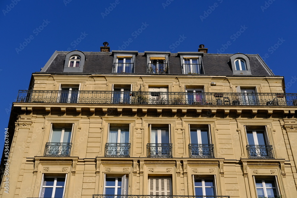 Paris, France - March, 26th 2022: Some traditional buildings in Paris center. (district: le Marais). Paris, France - March, 26th 2022: Some traditional buildings in Paris center. (district: le Marais).