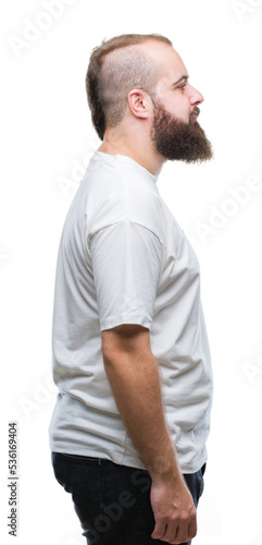 Young caucasian hipster man wearing casual t-shirt over isolated background looking to side, relax profile pose with natural face with confident smile.