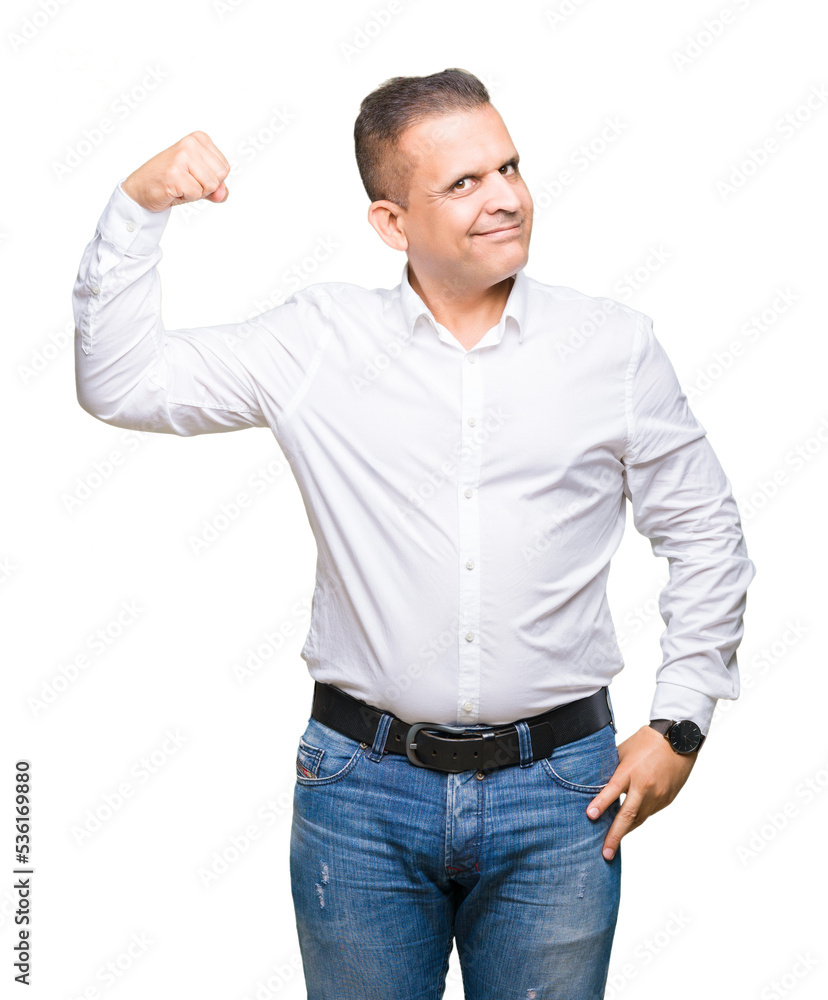 Middle age arab elegant man over isolated background Strong person showing arm muscle, confident and proud of power