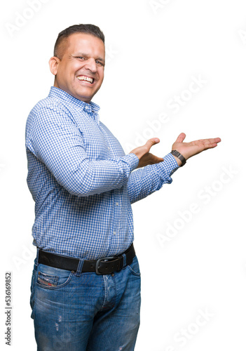 Middle age arab business man over isolated background Inviting to enter smiling natural with open hand