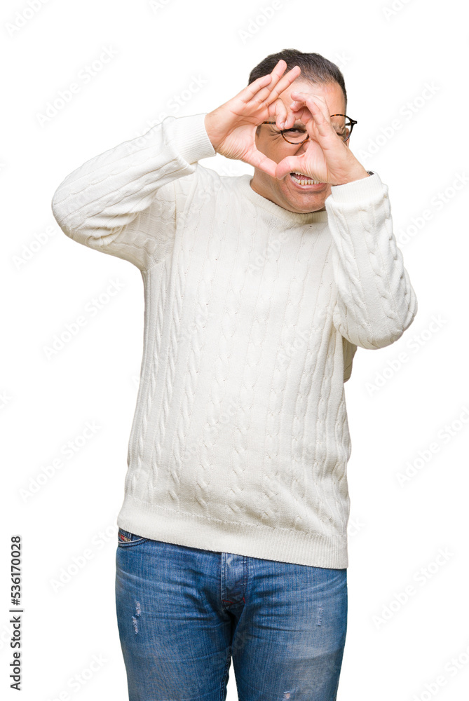 Fototapeta premium Middle age arab man wearing glasses over isolated background Doing heart shape with hand and fingers smiling looking through sign