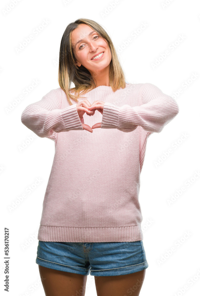 Young beautiful woman wearing winter sweater over isolated background smiling in love showing heart symbol and shape with hands. Romantic concept. Young beautiful woman wearing winter sweater over isolated background smiling in love showing heart symbol and shape with hands. Romantic concept.