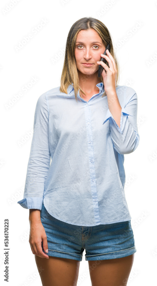 Young beautiful woman talking on smartphone over isolated background with a confident expression on smart face thinking serious Young beautiful woman talking on smartphone over isolated background with a confident expression on smart face thinking serious