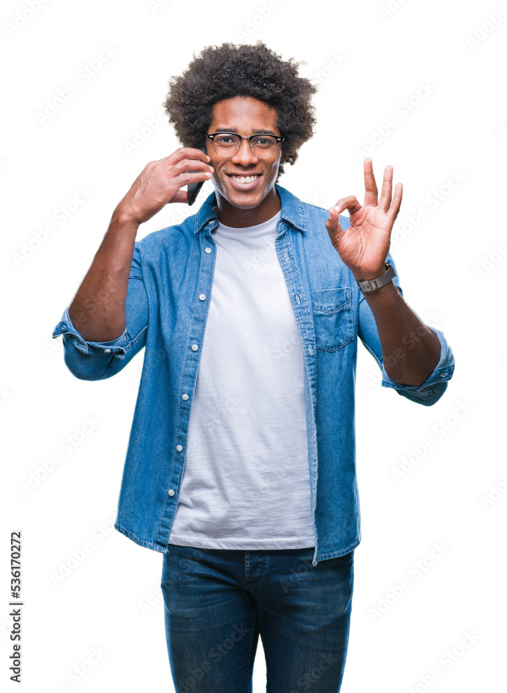 Afro american man talking on the phone over isolated background doing ok sign with fingers, excellent symbol Afro american man talking on the phone over isolated background doing ok sign with fingers, excellent symbol
