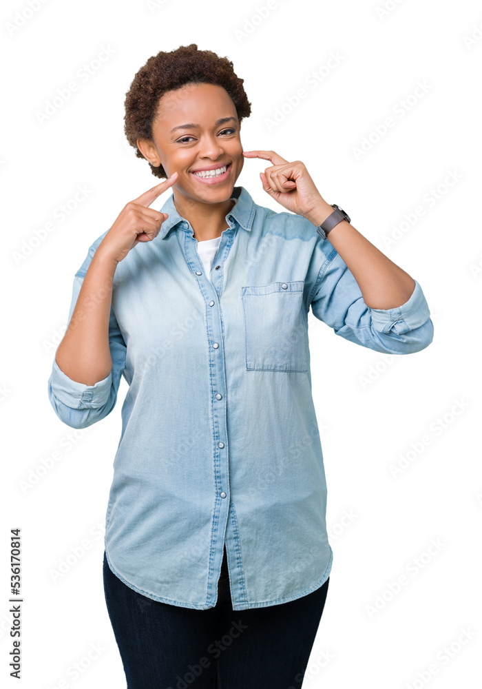 Young beautiful african american woman over isolated background smiling confident showing and pointing with fingers teeth and mouth. Health concept.