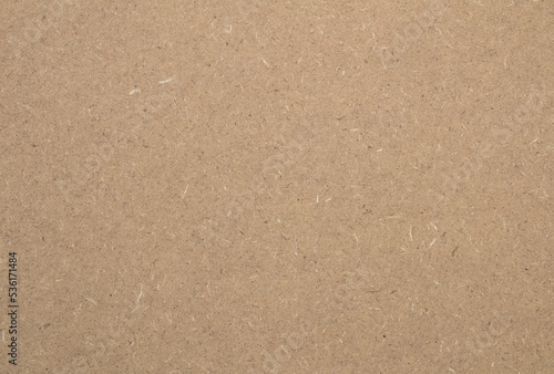 Background - mdf board texture which is brownish yellow in color.
