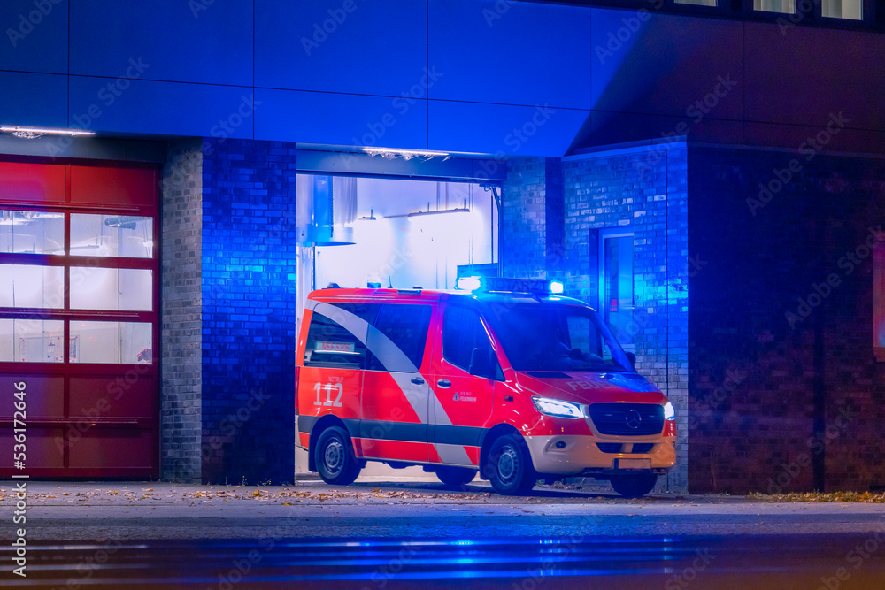 Fototapeta premium Ambulance at night, blue light, fire department, berlin, germany, abstract