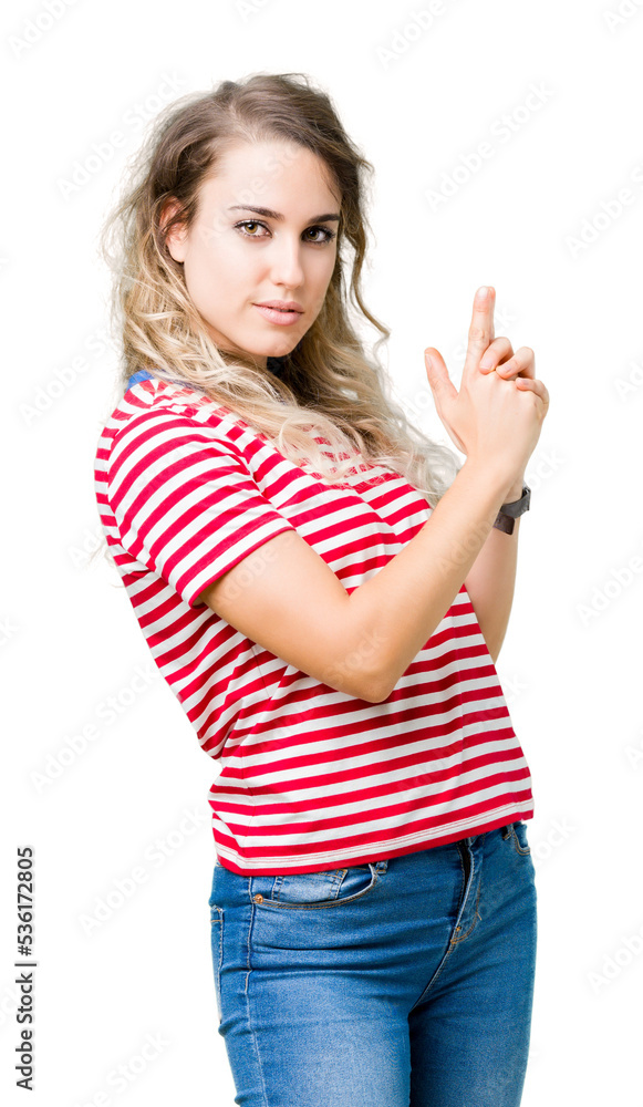 Beautiful young blonde woman over isolated background Holding symbolic gun with hand gesture, playing killing shooting weapons, angry face Beautiful young blonde woman over isolated background Holding symbolic gun with hand gesture, playing killing shooting weapons, angry face