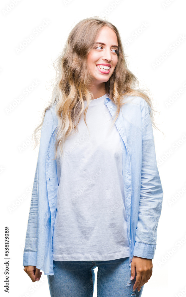 Beautiful young blonde woman over isolated background looking away to side with smile on face, natural expression. Laughing confident. Beautiful young blonde woman over isolated background looking away to side with smile on face, natural expression. Laughing confident.