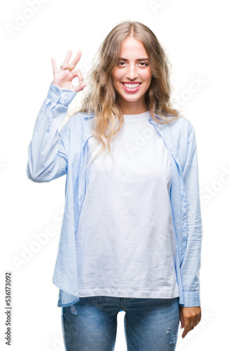 Beautiful young blonde woman over isolated background smiling positive doing ok sign with hand and fingers. Successful expression.