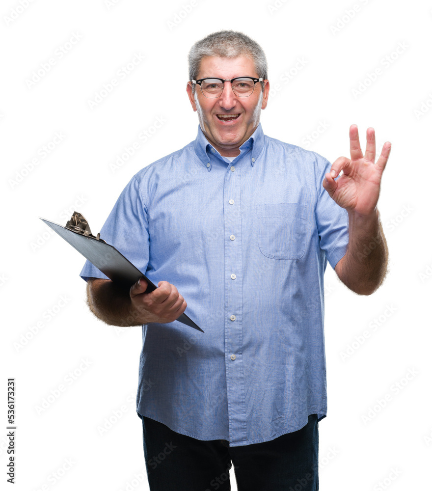 Handsome senior inspector man holding clipboard over isolated background doing ok sign with fingers, excellent symbol Handsome senior inspector man holding clipboard over isolated background doing ok sign with fingers, excellent symbol