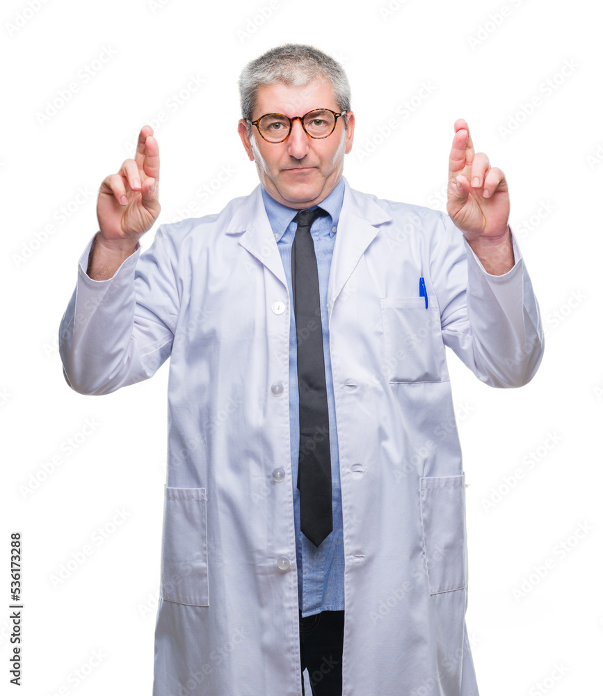 Handsome senior doctor, scientist professional man wearing white coat over isolated background smiling crossing fingers with hope and eyes closed. Luck and superstitious concept. Handsome senior doctor, scientist professional man wearing white coat over isolated background smiling crossing fingers with hope and eyes closed. Luck and superstitious concept.