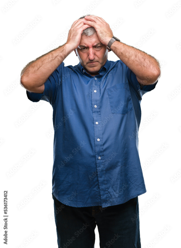 Handsome senior man over isolated background suffering from headache desperate and stressed because pain and migraine. Hands on head. Handsome senior man over isolated background suffering from headache desperate and stressed because pain and migraine. Hands on head.