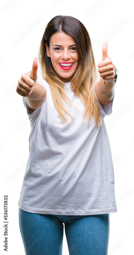 Young beautiful woman casual white t-shirt over isolated background approving doing positive gesture with hand, thumbs up smiling and happy for success. Looking at the camera, winner gesture. Young beautiful woman casual white t-shirt over isolated background approving doing positive gesture with hand, thumbs up smiling and happy for success. Looking at the camera, winner gesture.