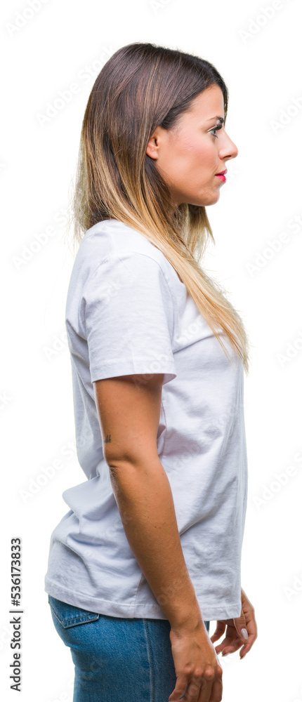 Young beautiful woman casual white t-shirt over isolated background looking to side, relax profile pose with natural face with confident smile. Young beautiful woman casual white t-shirt over isolated background looking to side, relax profile pose with natural face with confident smile.