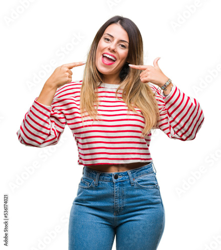 Young beautiful woman casual stripes winter sweater over isolated background smiling confident showing and pointing with fingers teeth and mouth. Health concept.