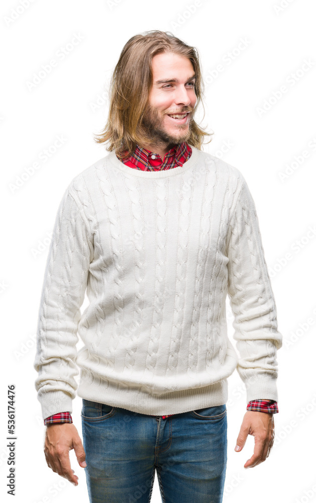 Young handsome man with long hair wearing winter sweater over isolated background looking away to side with smile on face, natural expression. Laughing confident. Young handsome man with long hair wearing winter sweater over isolated background looking away to side with smile on face, natural expression. Laughing confident.