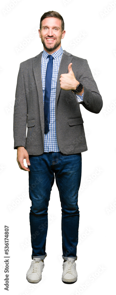 Handsome business man wearing suit and tie doing happy thumbs up gesture with hand. Approving expression looking at the camera with showing success. Handsome business man wearing suit and tie doing happy thumbs up gesture with hand. Approving expression looking at the camera with showing success.
