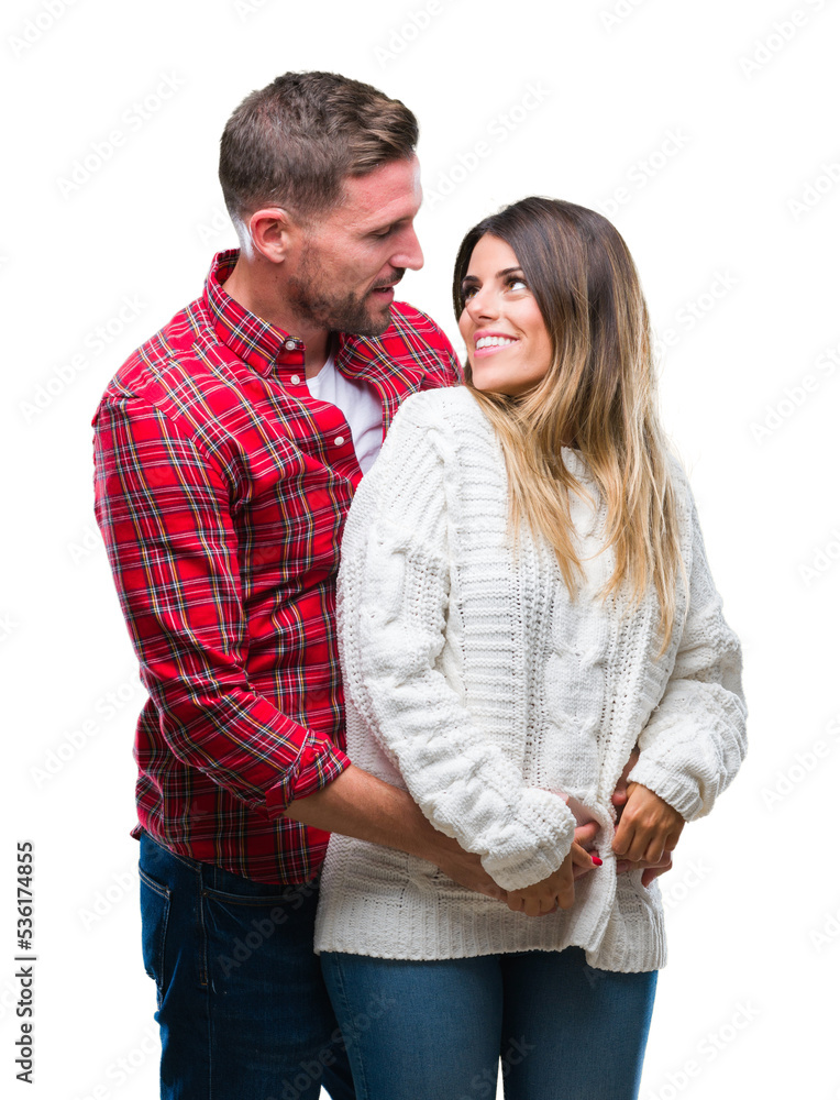 Young couple in love wearing winter sweater over isolated background looking away to side with smile on face, natural expression. Laughing confident. Young couple in love wearing winter sweater over isolated background looking away to side with smile on face, natural expression. Laughing confident.