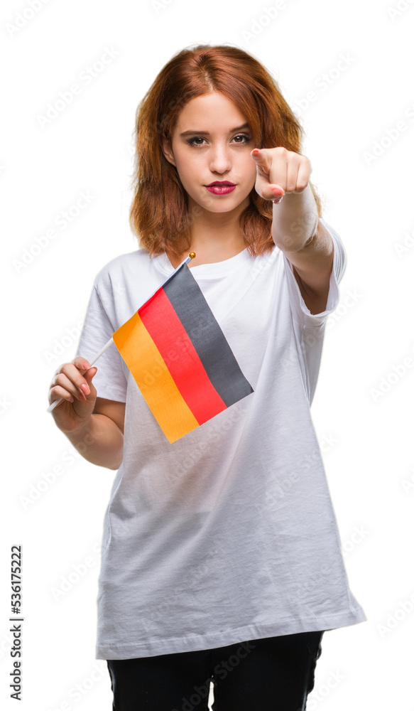 Young beautiful woman holding flag of germany over isolated background pointing with finger to the camera and to you, hand sign, positive and confident gesture from the front Young beautiful woman holding flag of germany over isolated background pointing with finger to the camera and to you, hand sign, positive and confident gesture from the front
