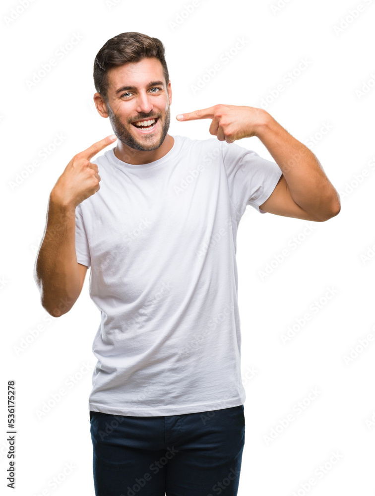 Young handsome man over isolated background smiling confident showing and pointing with fingers teeth and mouth. Health concept. Young handsome man over isolated background smiling confident showing and pointing with fingers teeth and mouth. Health concept.