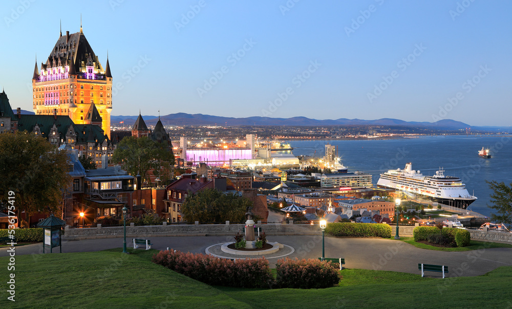 Fototapeta premium Quebec City and St. Lawrence River with a cruise ship at dusk, Canada