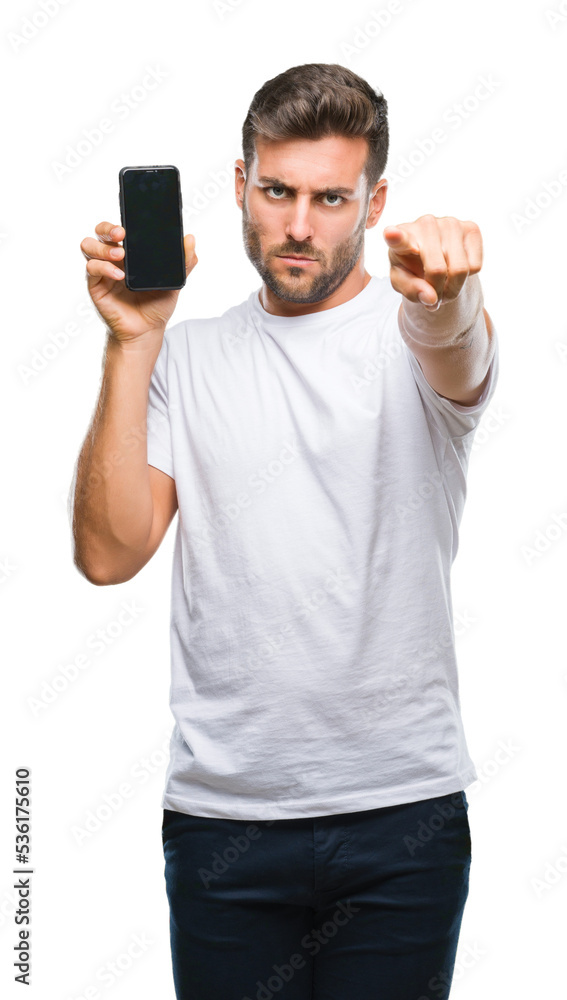 Young handsome man showing smartphone screen over isolated background pointing with finger to the camera and to you, hand sign, positive and confident gesture from the front Young handsome man showing smartphone screen over isolated background pointing with finger to the camera and to you, hand sign, positive and confident gesture from the front