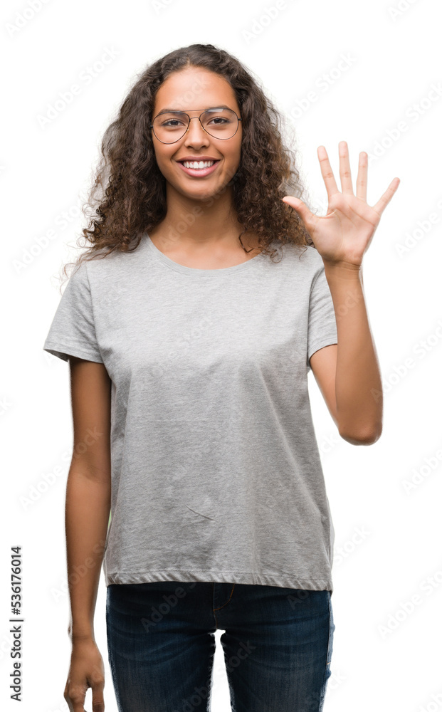 Beautiful young hispanic woman wearing glasses showing and pointing up with fingers number five while smiling confident and happy. Beautiful young hispanic woman wearing glasses showing and pointing up with fingers number five while smiling confident and happy.