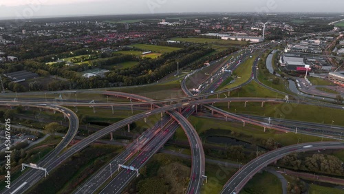 Rotating aerial hyper lapse of busy highway intersection node Prins Clausplein in the Netherlands at rush hour after sunset photo