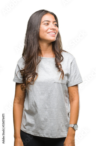 Young beautiful arab woman over isolated background looking away to side with smile on face, natural expression. Laughing confident.