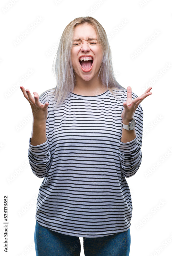 Young blonde woman over isolated background crazy and mad shouting and yelling with aggressive expression and arms raised. Frustration concept. Young blonde woman over isolated background crazy and mad shouting and yelling with aggressive expression and arms raised. Frustration concept.