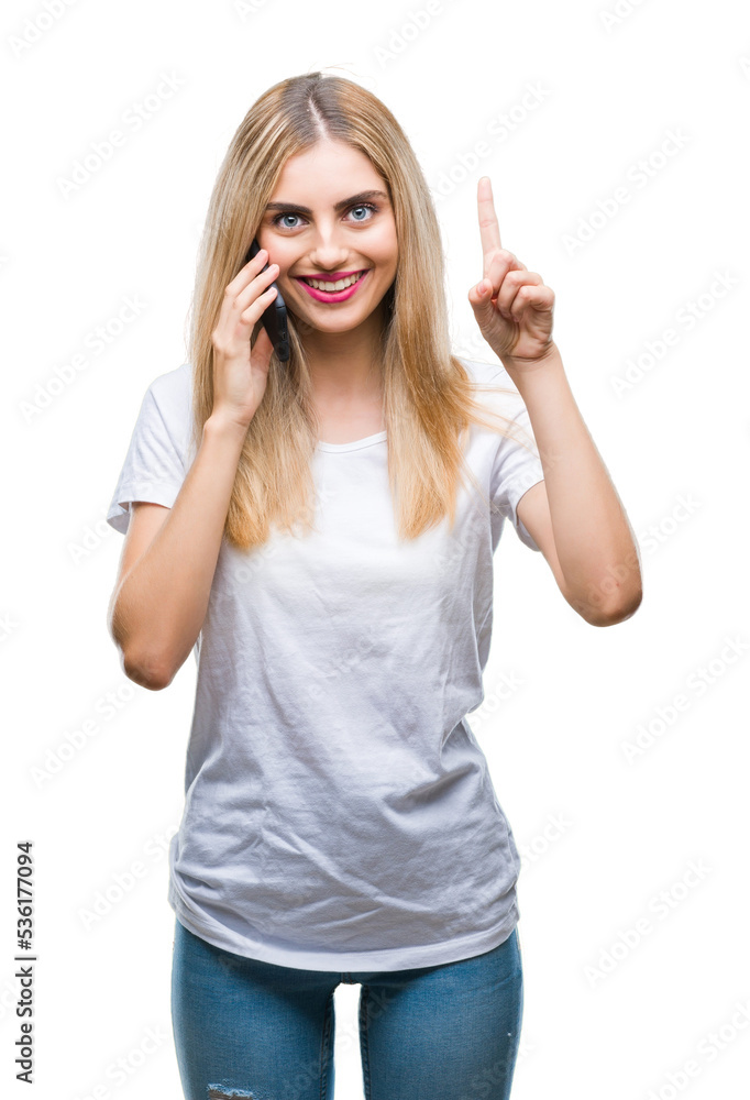 Young beautiful blonde woman talking using smartphone over isolated background surprised with an idea or question pointing finger with happy face, number one Young beautiful blonde woman talking using smartphone over isolated background surprised with an idea or question pointing finger with happy face, number one