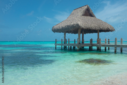 Fototapeta Naklejka Na Ścianę i Meble -  Caribbean beach cabin with clear sea water and blue sky