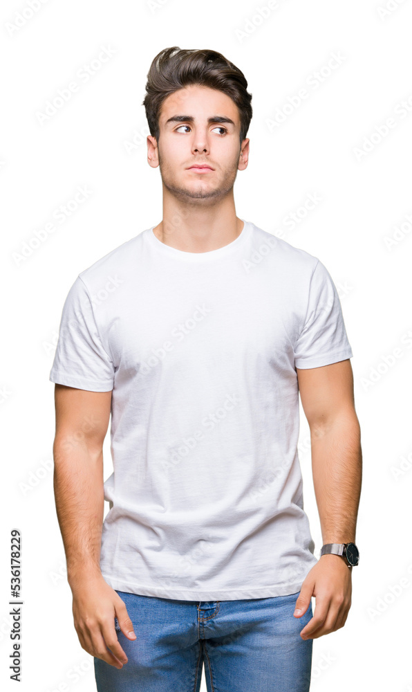 Young handsome man wearing white t-shirt over isolated background smiling looking side and staring away thinking. Young handsome man wearing white t-shirt over isolated background smiling looking side and staring away thinking.