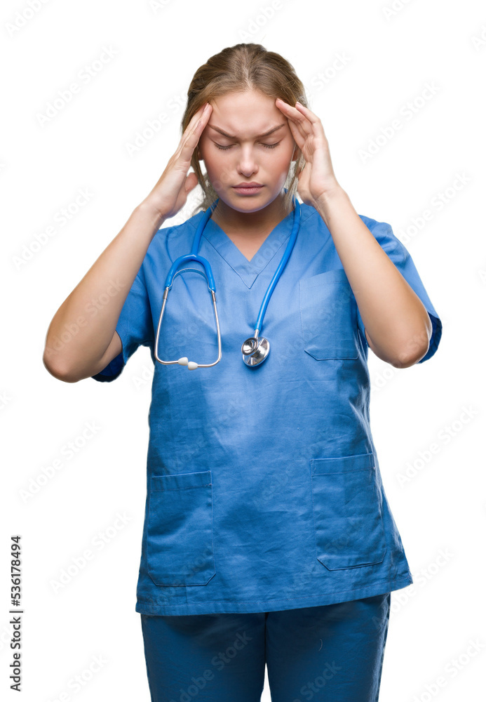 Young caucasian doctor woman wearing surgeon uniform over isolated background with hand on head for pain in head because stress. Suffering migraine. Young caucasian doctor woman wearing surgeon uniform over isolated background with hand on head for pain in head because stress. Suffering migraine.