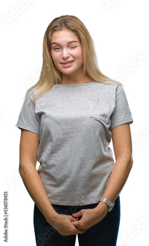Young caucasian woman over isolated background winking looking at the camera with sexy expression, cheerful and happy face.