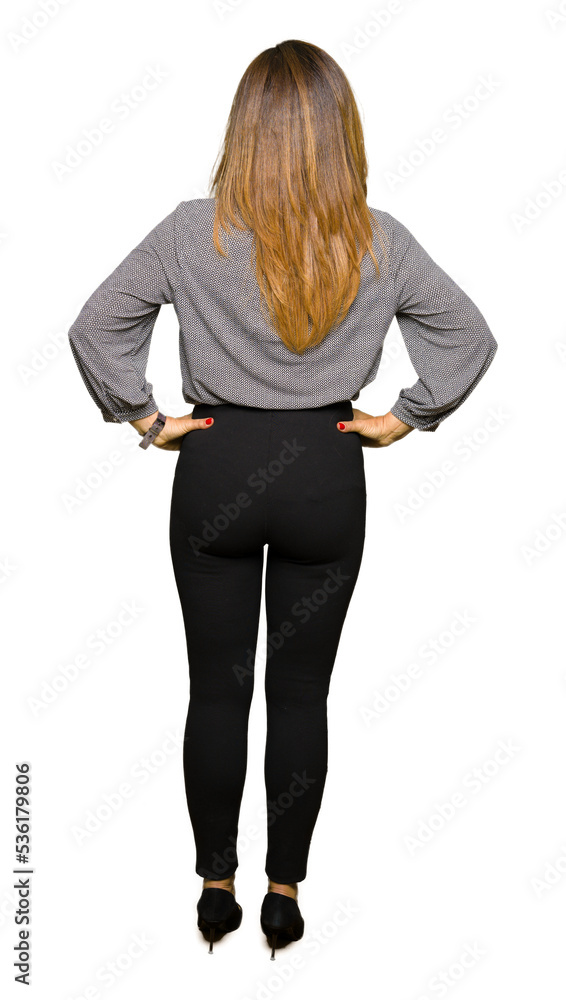 Beautiful middle age business woman standing backwards looking away with arms on body Beautiful middle age business woman standing backwards looking away with arms on body