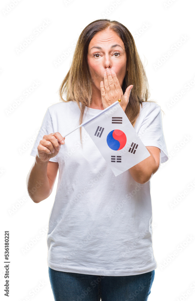 Middle age hispanic woman holding flag of South Korea over isolated background cover mouth with hand shocked with shame for mistake, expression of fear, scared in silence, secret concept Middle age hispanic woman holding flag of South Korea over isolated background cover mouth with hand shocked with shame for mistake, expression of fear, scared in silence, secret concept