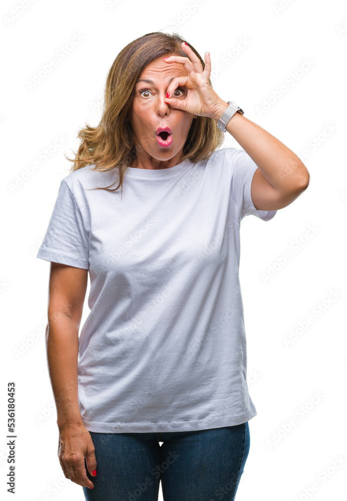 Middle age senior hispanic woman over isolated background doing ok gesture shocked with surprised face, eye looking through fingers. Unbelieving expression. Middle age senior hispanic woman over isolated background doing ok gesture shocked with surprised face, eye looking through fingers. Unbelieving expression.