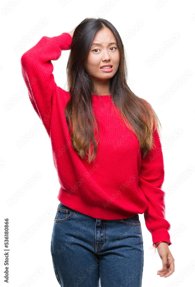 Young asian woman wearing winter sweater over isolated background confuse and wonder about question. Uncertain with doubt, thinking with hand on head. Pensive concept. Young asian woman wearing winter sweater over isolated background confuse and wonder about question. Uncertain with doubt, thinking with hand on head. Pensive concept.