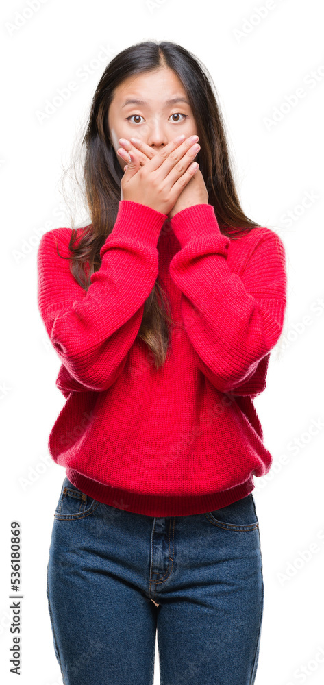 Young asian woman wearing winter sweater over isolated background shocked covering mouth with hands for mistake. Secret concept. Young asian woman wearing winter sweater over isolated background shocked covering mouth with hands for mistake. Secret concept.