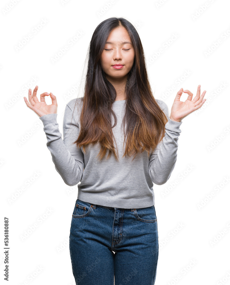 Young asian woman over isolated background relax and smiling with eyes closed doing meditation gesture with fingers. Yoga concept. Young asian woman over isolated background relax and smiling with eyes closed doing meditation gesture with fingers. Yoga concept.