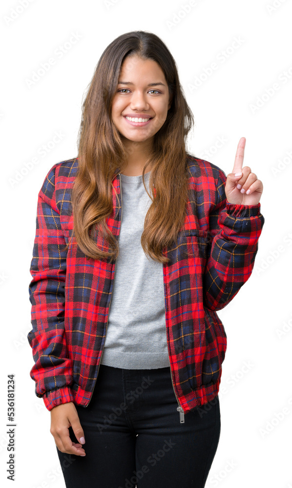 Young beautiful brunette woman wearing a jacket over isolated background showing and pointing up with finger number one while smiling confident and happy. Young beautiful brunette woman wearing a jacket over isolated background showing and pointing up with finger number one while smiling confident and happy.