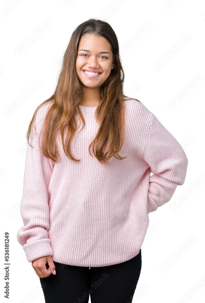 Young beautiful brunette woman wearing pink winter sweater over isolated background with a happy and cool smile on face. Lucky person. Young beautiful brunette woman wearing pink winter sweater over isolated background with a happy and cool smile on face. Lucky person.